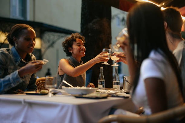 istock Group of Young Adults Enjoying Outdoor Dinner 2198272697