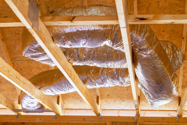 istock Installing ventilation HVAC pipes with silver insulation on roof a ceiling during construction 2198274839