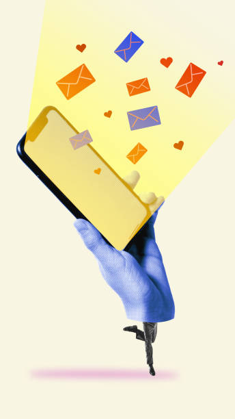 istock Instant messaging. Hand holding phone with glowing screen and flowing mails and hearts symbolizing notifications, connections and conversation 2198275637