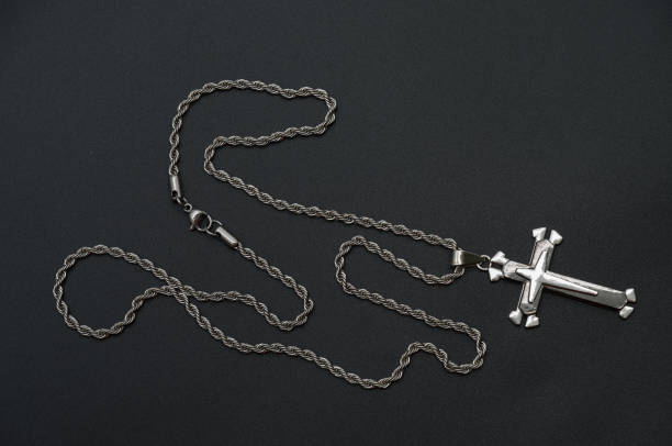 istock a silver chain with a cross on a black background 2198276774