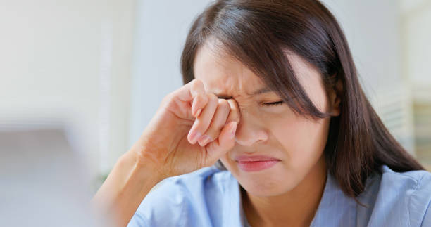 istock woman eyes pain at work 2198279360