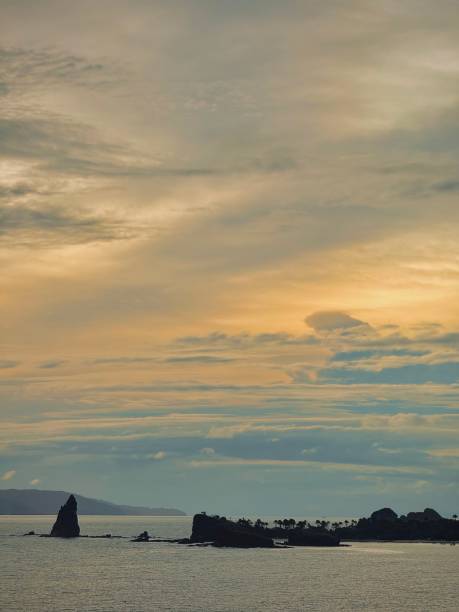 istock Golden Sunset Over Remote Ocean Island with Dramatic Sky 2198280867