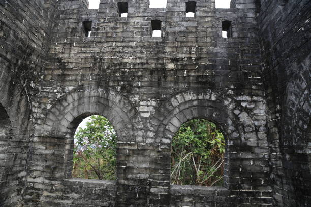 istock A stone wall with arched windows, a gray color scheme, weathered texture, an ancient Chinese-inspired style 2198281469
