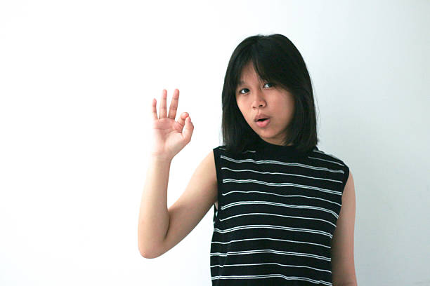 Asian girl image with ok gesture, mouth open, isolated. copy space.
