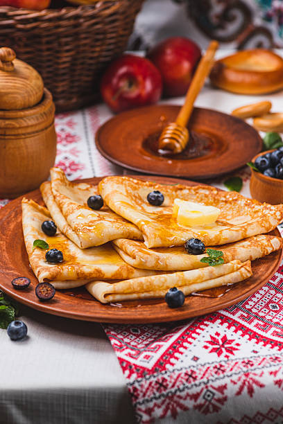 istock Pancakes with honey and berries on the table next to the samovar 2198283514