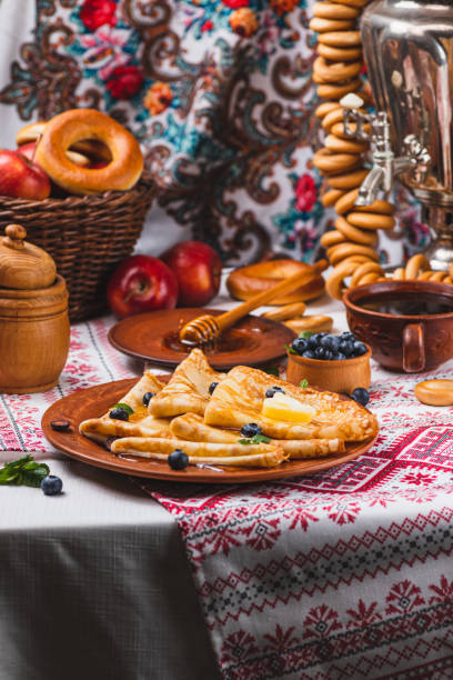 istock Pancakes with honey and berries on the table next to the samovar 2198283529
