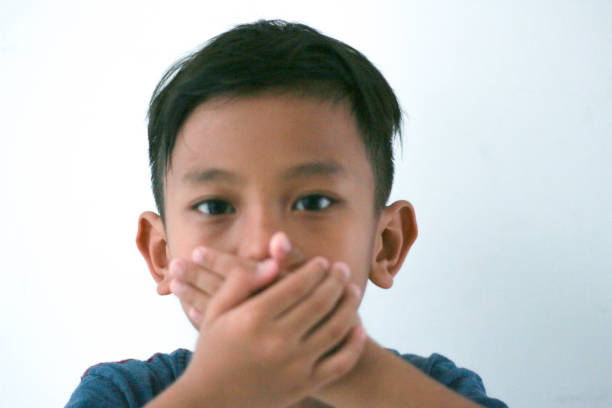 Portrait Of Cute Boy Against White Background