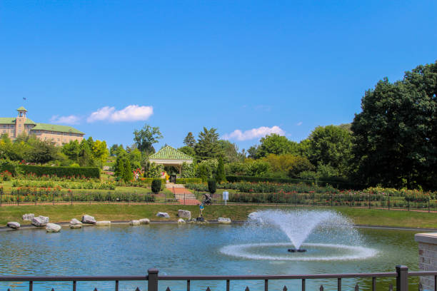 istock Beautiful garden pond with fountain under a clear blue sky 2198286524