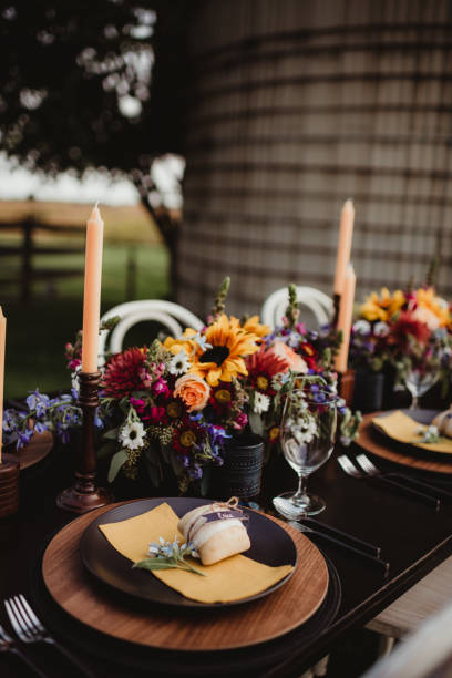 istock Outdoor wedding reception dinner table set up with autumn colored flowers and candles 2198287398