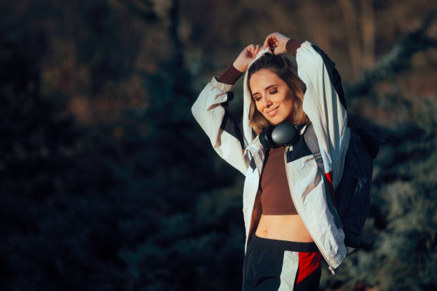 istock Happy Hiker Wearing a Backpack Fixing her Hair 2198289210