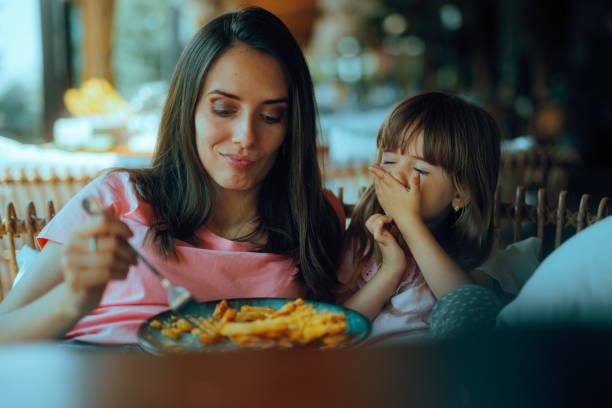 istock Little Girl Covering Her Mouth Refusing her Mom feeding 2198290594