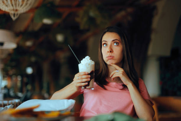 istock Surprised Woman Holding a Whipped Cream Coffee Beverage 2198290603