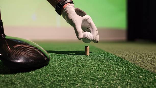 istock Golfer preparing to tee off at indoor driving range 2198294305