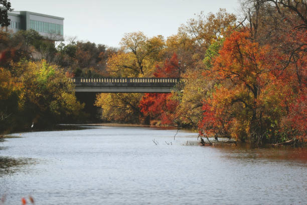 istock Autumnal Urban Water Scene with Distant Bridge and Building 2198295966