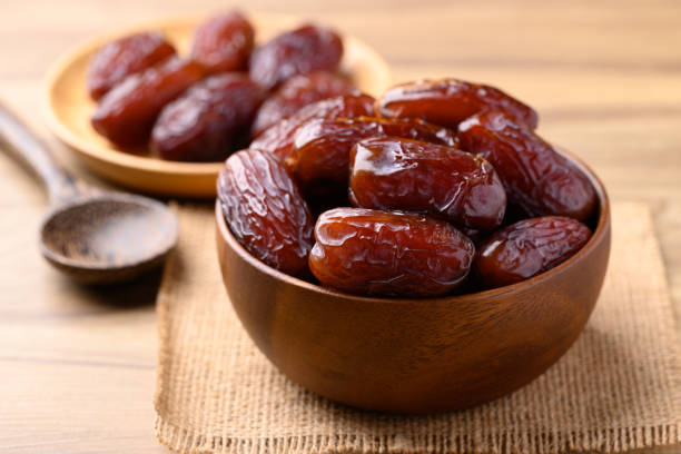 istock Date palm fruit (MedJool) in wooden bowl 2198299571