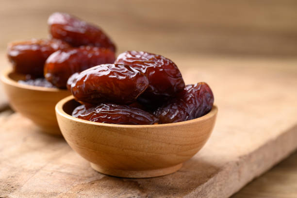 istock Date palm fruit (MedJool) in wooden bowl 2198299582