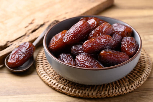 istock Date palm fruit (MedJool) in wooden bowl 2198299592
