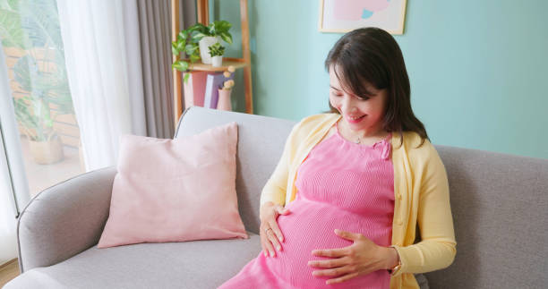 istock pregnant woman happy living room 2198299636