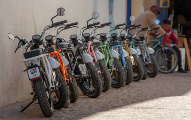 Motorcycles parked in a line on a street in Essaouira in Morocco