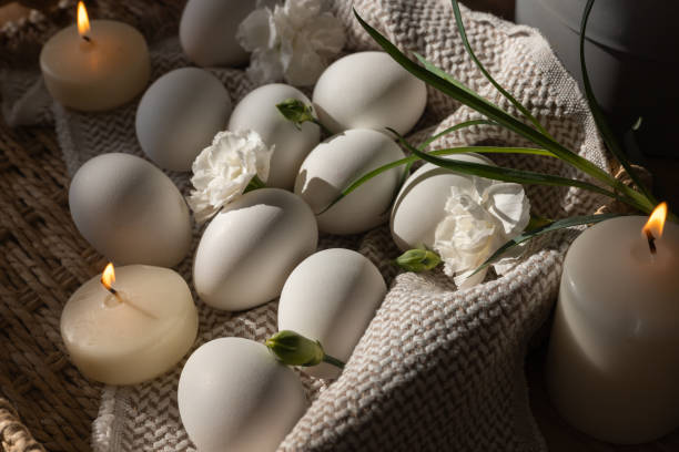 istock Decorative white eggs arranged with flowers and candles for Easter celebration in springtime 2198307465