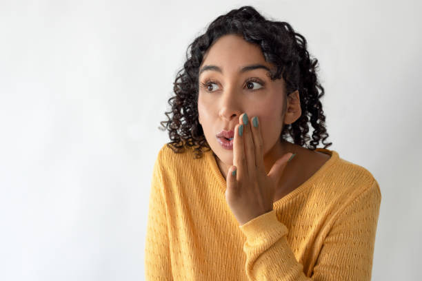 istock Young woman whispering and telling something 2198314734