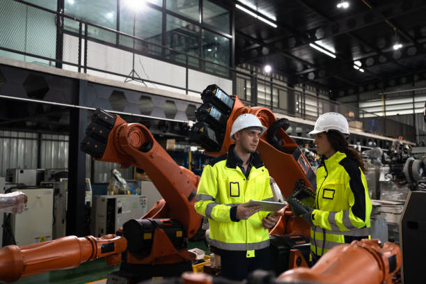 istock Engineer Caucasian male and female checking a robot arm with a digital tablet 2198316515