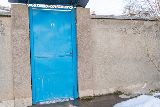 A vibrant blue metal door with the number \
