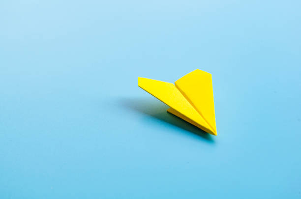 istock Origami of a single yellow airplane with customizable space for text 2198317031