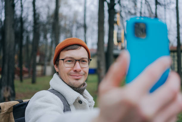 istock Tourist taking selfie in park with smartphone 2198320835
