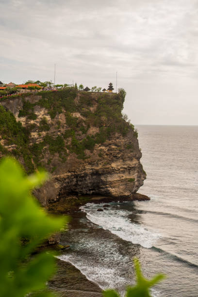 istock Sacred pagodas with terracotta roofs stand sentinel on towering cliffs, overlooking the churning Indian Ocean 2198321002