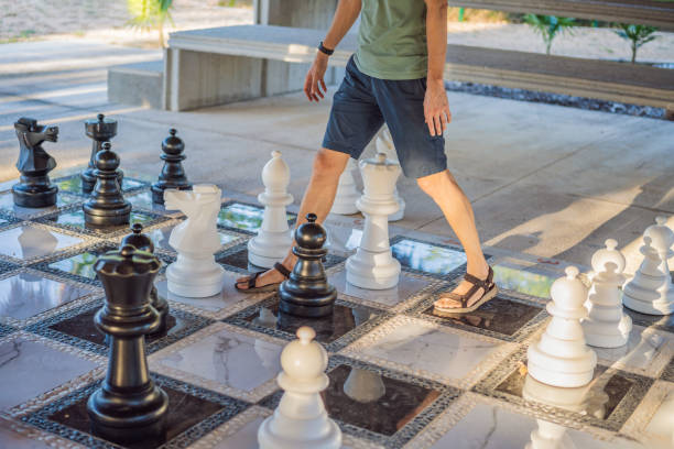 istock Father and son playing chess spending time together outdoor. Kid play chess 2198321959