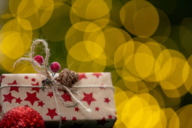 A wrapped Christmas gift with red stars, set against a dreamy bokeh backdrop, creating a magical scene