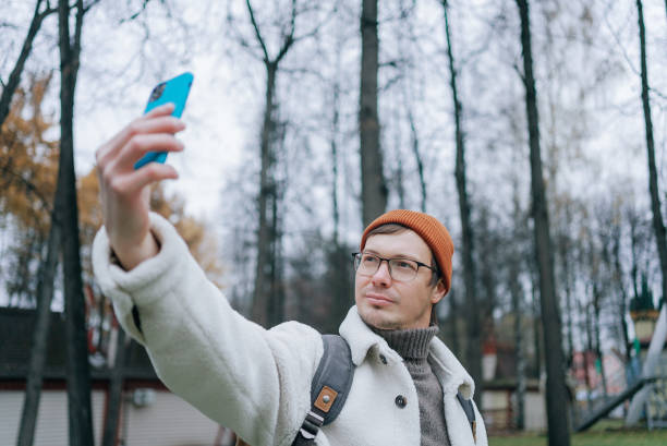 istock Tourist taking selfie in park during cold season 2198322213