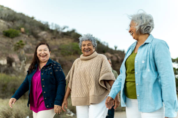 istock Senior friends walking and talking outdoors 2198322227