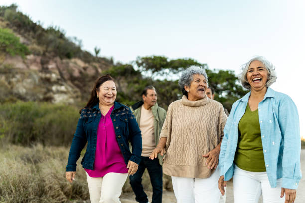 Senior friends walking and talking outdoors