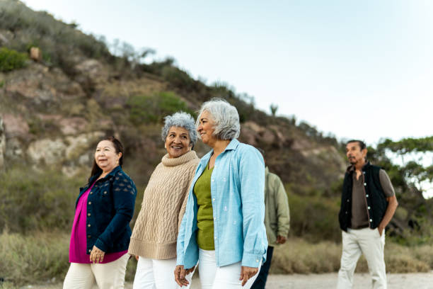 istock Senior friends walking and talking outdoors 2198322237