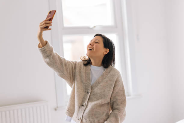 istock Woman taking selfie at home 2198322297