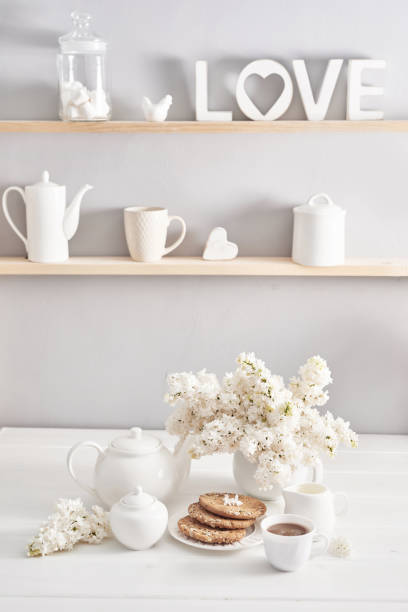 istock Tea set, cookies and white lilac on kitchen table. Happy birthday greeting card. Hello spring and summer. Greeting card for Women's Day and Mother's Day. Spring season, copy space.Romantic breakfast 2198323014