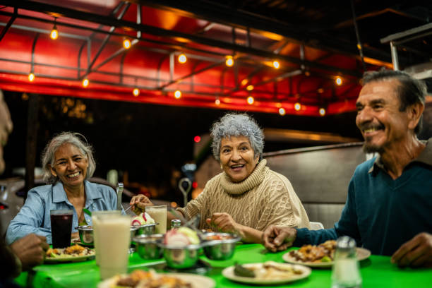 istock Senior friends talking and eating on restaurant 2198323852