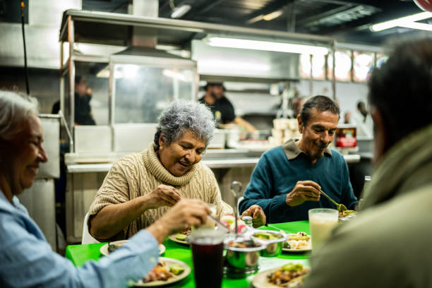 istock Senior friends talking and eating on restaurant 2198323855