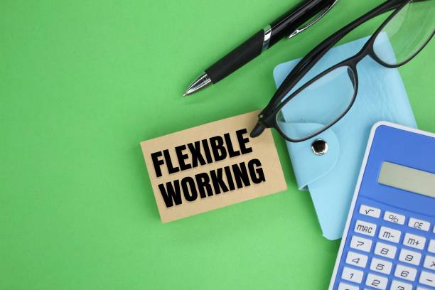 istock Pen,calculator, magnifying glass with the word Flexible working 2198324249
