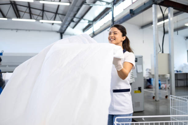 istock Cheerful dry cleaning worker and laundry washing. 2198325814