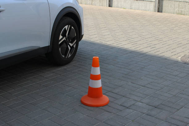 istock Orange Traffic Cone On The Parking Place At Open Air Parking 2198325858