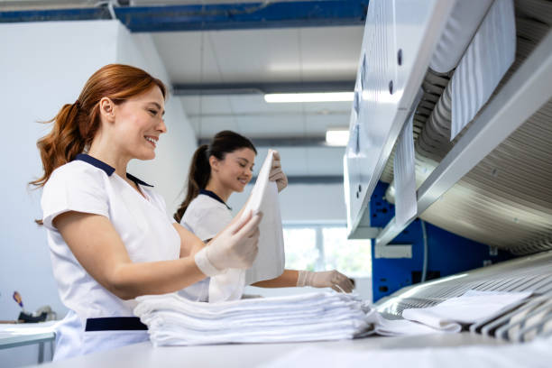 istock Dry cleaning business. Preparing clean laundry for ironing. 2198325980