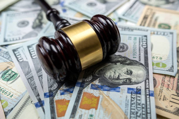 istock Judge's hammer lying on 100 new dollar money 2198331684