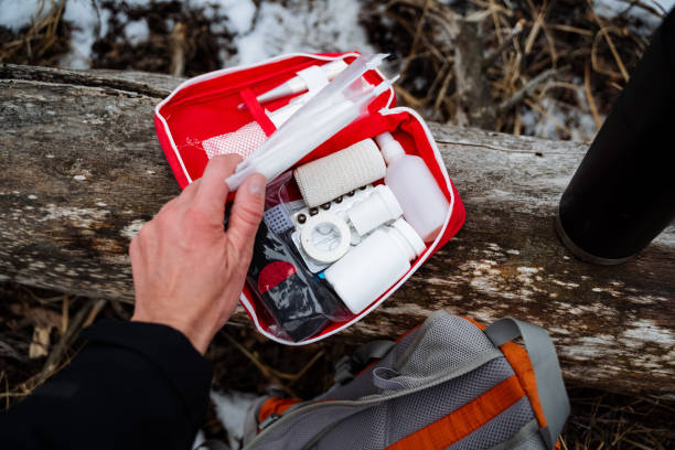istock A person confidently holds a wellstocked first aid kit right next to their backpack, fully prepared for any unforeseen emergencies that might arise during their exciting adventures 2198332337