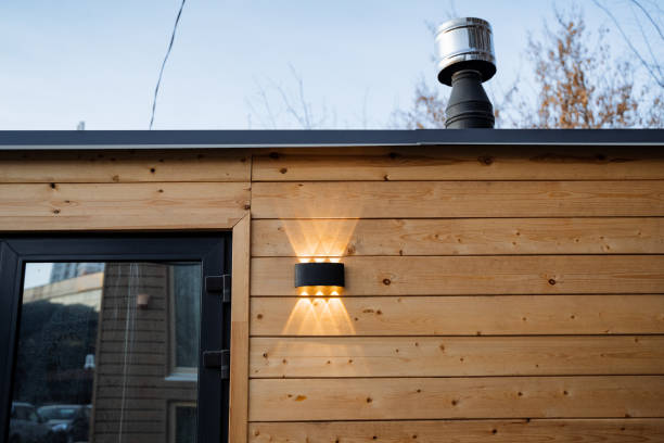 istock This charming wooden building, featuring an elegant black door and a beautifully constructed chimney, truly fosters a welcoming atmosphere amid its beautifully landscaped surroundings 2198332472