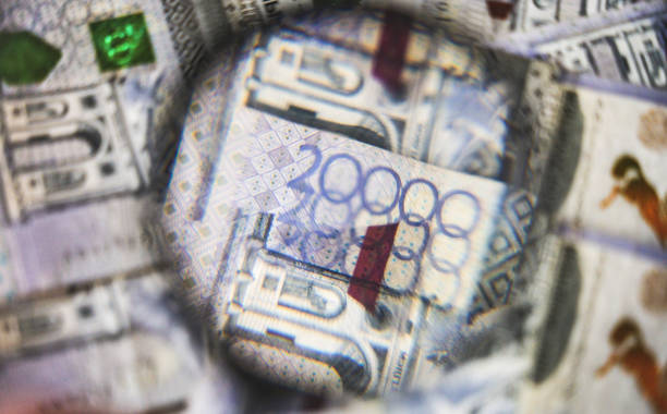 istock Part of a blurred tenge banknote through a magnifying glass 2198332837