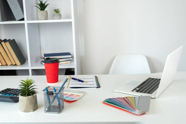istock Designer  workplace laptop color sampler catalog empty notepad pen and coffee at office desk 2198332958