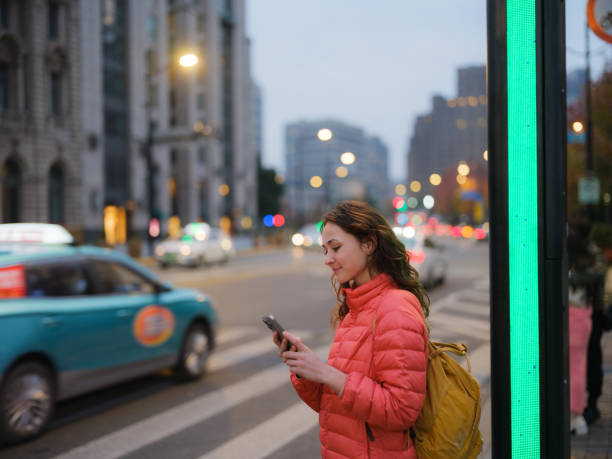 istock Woman using smartphone on the move exploring the city in China 2198333081
